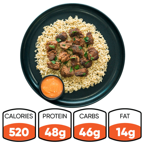 GLORIOUS GAINS Steak Bites Cilantro Lime Rice: High-protein meal with steak bites over cilantro lime rice and orange sauce. Nutrition: 520 calories, 48g protein, 46g carbs, 14g fat.