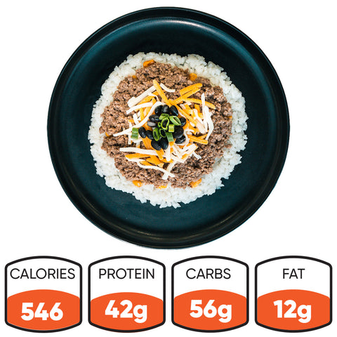 The Honey Garlic Beef Bowl features white rice, ground meat, shredded cheese, black beans, and green onions. This high-protein meal prep option has 546 calories, 42g protein, 56g carbs, and 12g fat.